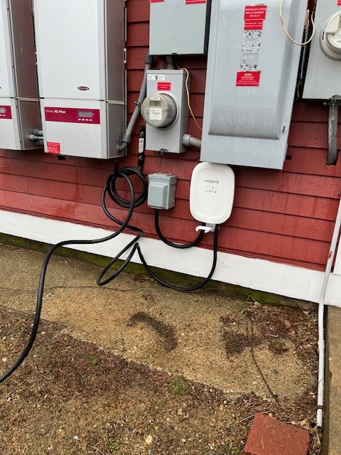An electronic vehicle charging station installed at Dismas Family Farm among other electrical systems and components