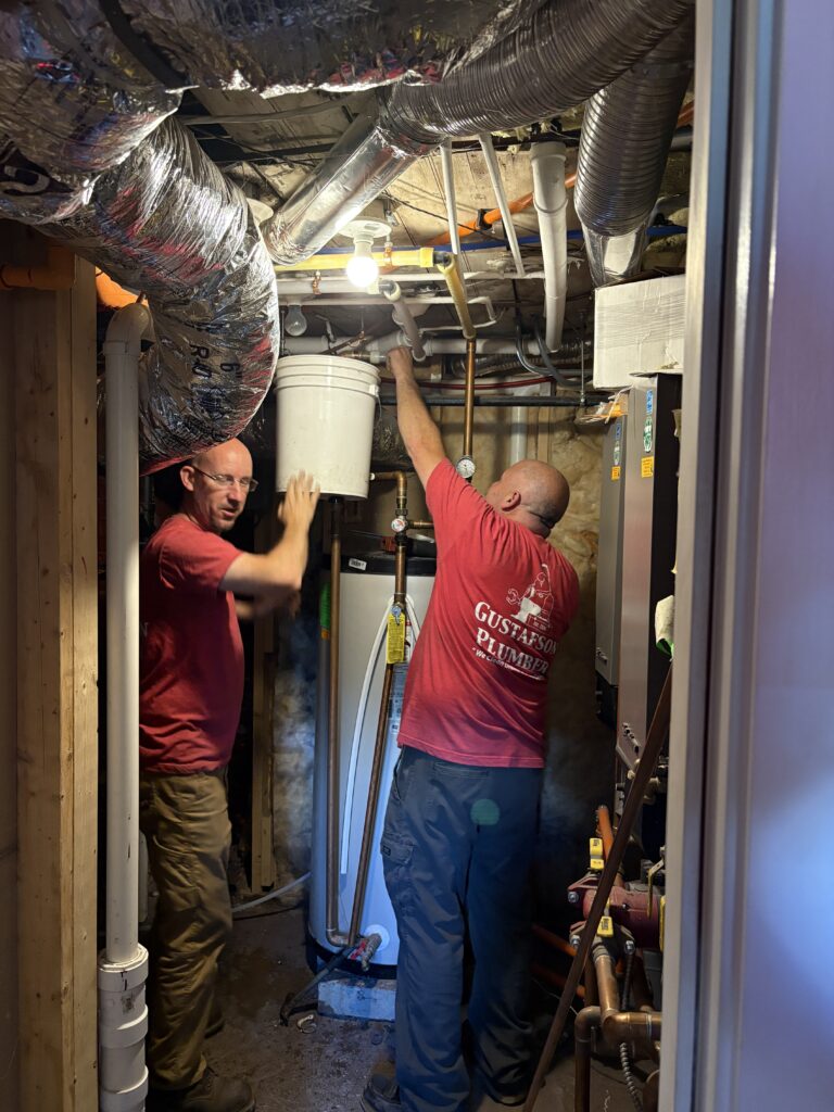 plumbers installing a recirculation line to improve hot water availability